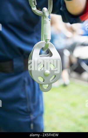 Mann mit Höhengeräten, Karabinern, Blockrollen. Industrieller Bergsteiger, Höhe, Versicherungskonzept Stockfoto