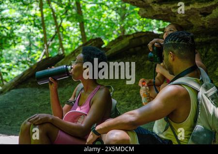 Junge Wanderer, die im Wald Pause machen Stockfoto