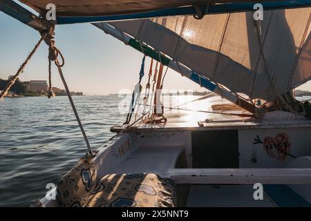 Ein Blick von einem traditionellen Segelboot auf dem Nil in der Nähe von Luxor zeigt das Segel, das Nachmittagslicht fängt Stockfoto