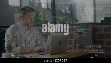 Bild mathematischer Gleichungen über kaukasische Geschäftsleute, die im Büro am Laptop arbeiten Stockfoto