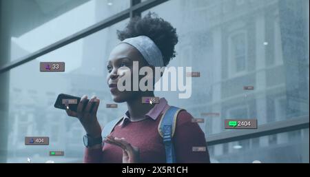 Bild von Social-Media-Ikonen mit Zahlen über afroamerikanerin, die auf dem Smartphone spricht Stockfoto