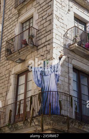 Ein Riese einer Hexe in einem blauen Gewand ist auf einem Balkon. Girona in Temps de Flors 2024 Stockfoto