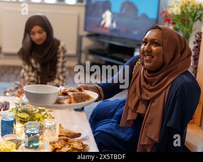 Frauen teilen sich während des Ramadan-Essens zu Hause Essen Stockfoto