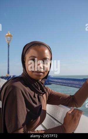 Porträt einer muslimischen Frau, die auf dem Seeweg in die Kamera schaut Stockfoto