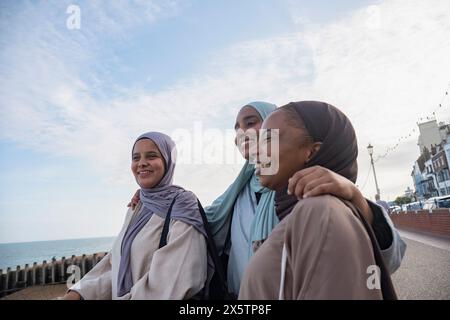 Drei muslimische Frauen mit Blick auf das Meer Stockfoto