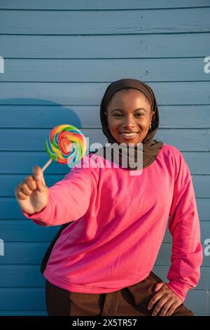 Porträt einer muslimischen Frau, die Lutscher hält Stockfoto