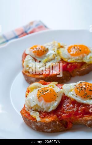 Gebratene Wachteleier mit Pisto Manchego auf Toast. Ansicht schließen. Stockfoto