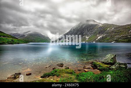 Panorama des Djupvatnet-Sees in der Nähe des Dalsnibba-Berges und des Geirangerfjords in Norwegen. Lange Belichtung. Berge. Wolken Stockfoto