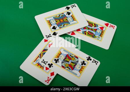 Spielkarten für Poker und Glücksspiel, isoliert auf grünem Hintergrund. Stockfoto