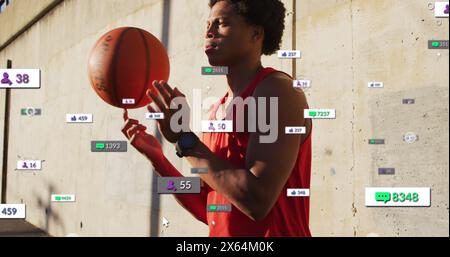 Abbildung: Mehrere Benachrichtigungsbalken über birassischem Spieler, der Basketball auf dem Finger dreht Stockfoto