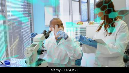 Bild der medizinischen Datenverarbeitung an diversen männlichen und weiblichen Wissenschaftlern, die im Labor diskutieren Stockfoto