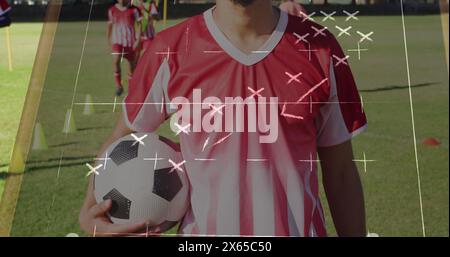 Bild von Spielplänen über verschiedene Fußballspieler im Stadion Stockfoto