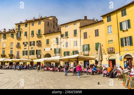 Die Leute essen und trinken in den Restaurants auf dem Anfiteatro-Platz in Lucca, Italien Stockfoto