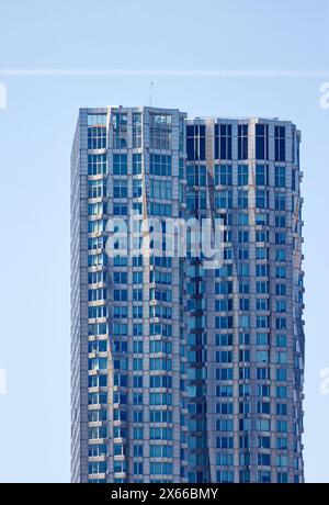 Fassadendetail der 8 Spruce Street, früher bekannt als New York von Gehry, einem mit Edelstahl verkleideten Wohnturm in Lower Manhattan. Stockfoto