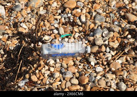 Entsorgte Plastikflasche mit der Marke Smart Water am Kieselstrand in Hastings, East Sussex, England, Großbritannien, 2024 tagsüber Stockfoto