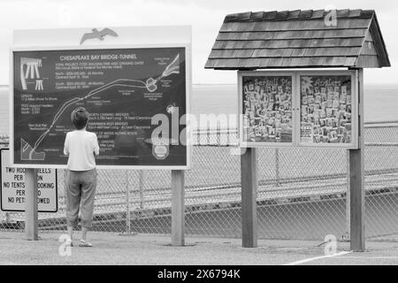 Frau liest Informationsschild an der Chesapeake Bay Bridge und Tunnel, Virginia, USA. Stockfoto