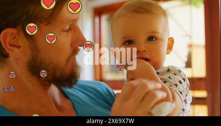 Bild von Herzsymbolen über dem kaukasischen Vater mit Baby Stockfoto