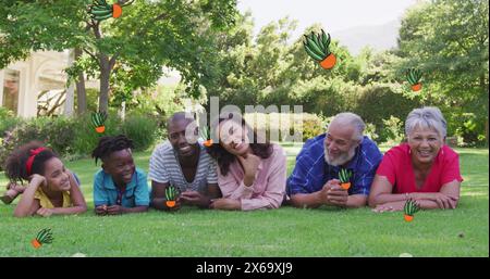 Bild von Pflanzensykonen über afroamerikanischer Familie im Garten Stockfoto