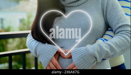 Bild von Neonherzen über glückliche, vielfältige Paare, die sich umarmen Stockfoto