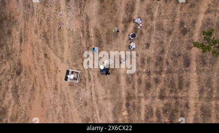 (240514) -- DONGCHUAN, 14. Mai 2024 (Xinhua) -- ein Luftdrohnenfoto vom 7. Mai 2024 zeigt Forscher, die Schichten auf dem Schwemmfächer des Schutzuflusses in der Schlucht Jiangjiagou im Bezirk Dongchuan in Kunming, südwestchinesische Provinz Yunnan, aufspüren. Die Jiangjiagou-Schlucht im Xiaojiang-Flussbecken war ein häufiges Erdrutschgebiet. Im Jahr 1961 wurde eine Beobachtungs- und Forschungsstation für Trümmerströme, bekannt als Dongchuan Station, im Gebiet von Jiangjiagou eingerichtet. Seitdem haben mehrere Generationen von Forschern Trümmerströme beobachtet und untersucht und einen Zusammenschluss erstellt Stockfoto