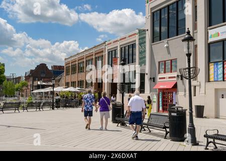 Alexandria, Virginia, USA - 1. Mai 2024: Menschen gehen entlang der Promenade am Ufer der Stadt vorbei an renovierten alten Gebäuden Stockfoto