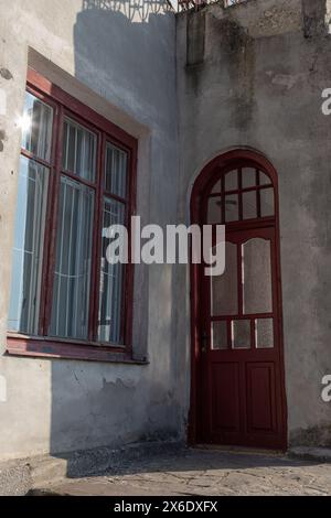 Ein altes altmodisches Holzfenster mit abblätternder Farbe und Rahmen müssten repariert oder ersetzt werden. Stockfoto