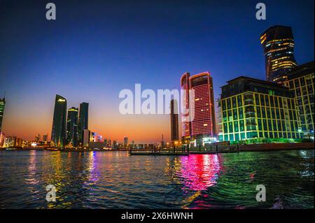 Nachtblick auf moderne Resorts, die sich im Wasser in Bahrain spiegeln Stockfoto