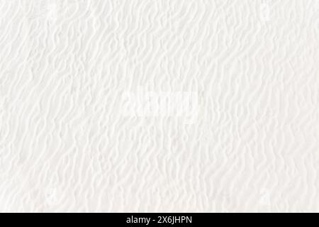 Sandwelle als Hintergrund. Weißer Sand an einem wilden Strand Stockfoto