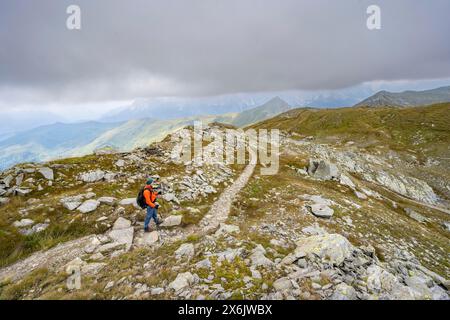 Bergsteiger auf einem Wanderweg hinunter zur Obstanserseehuette, zum Karnischen Hauptkamm, zum Karnischen Höhenweg, zu den Karnischen Alpen, Kärnten, Österreich Stockfoto