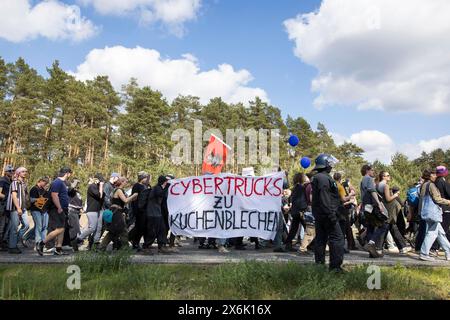 Teilnehmer mit Bannern Cybertrucks zu Kuchendosen am Demonstrationswasser. Wald. Gerechtigkeit gegen die Erweiterung der Tesla Gigafactory in Stockfoto