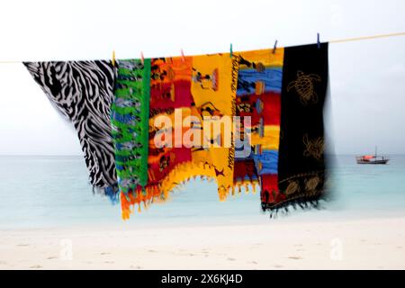 Bunte Stoffhandtücher wehen im Wind und trocknen auf der Wäscheleine am Strand, in der Nähe von Stonetown, Sansibar City, Sansibar, Tansania, Afrika Stockfoto