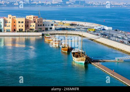Hafenblick mit Wolkenkratzern und Schiffen in Doha, der Hauptstadt von Katar am Persischen Golf. Stockfoto