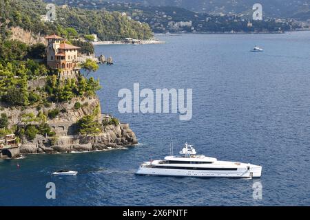 Erhöhter Blick auf das kap Punta Cajega mit der historischen Villa Beatrice und einer Mega-Yacht mit Abfahrt von Cannon Bay, Portofino, Genua, Ligurien, Italien Stockfoto