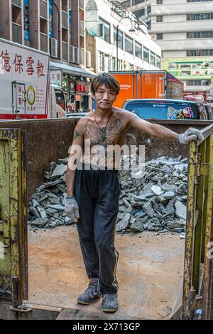 Eine Aufnahme eines tätowierten männlichen Arbeiters in hongkong Stockfoto