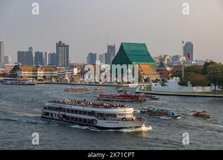 Ein Bild von mehreren Booten, die auf dem Chao Phraya River in Bangkok fahren. Stockfoto