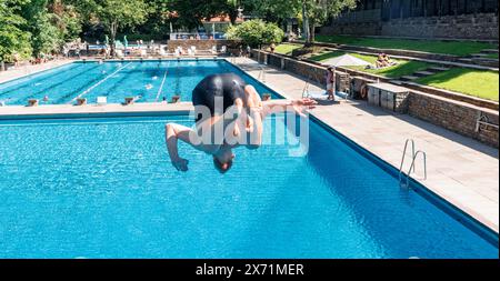 Hamburg, Deutschland. Mai 2024. Ein erster Besucher springt vom 3 Meter hohen Turm. Das Bäderland Hamburg läutet den Beginn der Outdoor-Saison ein und eröffnet das Kaifu-Schwimmbad. Quelle: Markus Scholz/dpa/Alamy Live News Stockfoto