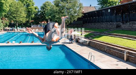 Hamburg, Deutschland. Mai 2024. Ein erster Besucher springt vom 3 Meter hohen Turm. Das Bäderland Hamburg läutet den Beginn der Outdoor-Saison ein und eröffnet das Kaifu-Schwimmbad. Quelle: Markus Scholz/dpa/Alamy Live News Stockfoto