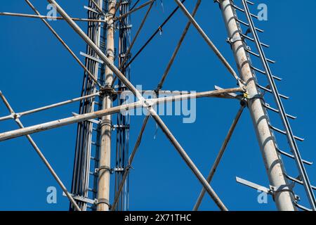 Stahlpylondetails, retikuläre Struktur einer Repeater-Antenne für Funk-, Telefon- und Kommunikationsbänder. Spurstangen und Muttern aus Edelstahl. Stockfoto