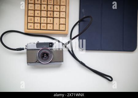 Filmkamera im Vintage-Stil sitzt auf dem Tisch im Büro. Es ist eine Filmkamera, die für Fotografen vorbereitet wurde, Fotos aufzunehmen und aufzunehmen, weil Filmkameras h Stockfoto