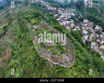 Qianxinan. Mai 2024. Ein Luftbild der Drohne, aufgenommen am 17. Mai 2024, zeigt einen Blick auf eine alte Stadtruine aus der Ming-Dynastie (1368–1644) im Dorf Pingzhai in der autonomen Präfektur Bouyei-Miao in Qianxinan, Provinz Guizhou im Südwesten Chinas. Der Ort wirkt von oben aus oval und erstreckt sich über eine Fläche von etwa 18.000 Quadratmetern, wobei mehr als 900 Meter Steinmauern erhalten geblieben sind. Quelle: Liu Xu/Xinhua/Alamy Live News Stockfoto