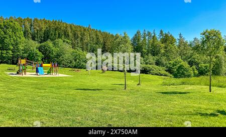 Perfekt gestreifter frisch gemähter Gartenrasen. Im Hintergrund des Spielplatzes Stockfoto