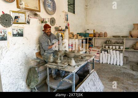 Fès, Marokko - 4. März 2024: Marokkanischer Töpfer arbeitet in seinem Töpferstudio in der Innenstadt von Fès im nördlichen Binnenland Marokkos Stockfoto