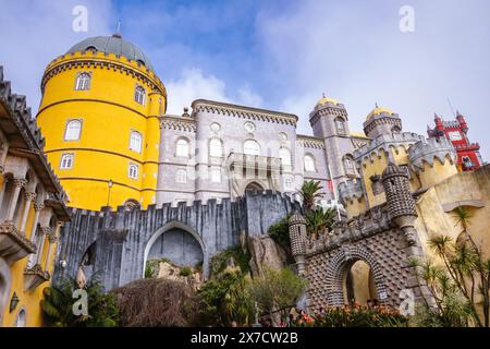 Der Pena-Palast oder das historische Schloss Palácio da Pena aus dem Kutschhof in Sintra, Portugal. Der märchenhafte Schlosspalast gilt als eines der schönsten Beispiele der portugiesischen Romantik des 19. Jahrhunderts der Welt. Stockfoto