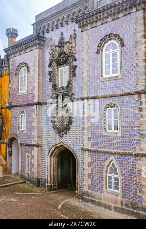 Geometrisch-maurische Fliesen, bekannt als Azulejos, schmücken die Fassade, die als Kloster des Ordens Christi im Pena Palast oder Palácio da Pena historisches Schloss in Sintra, Portugal, bekannt ist. Der märchenhafte Schlosspalast gilt als eines der schönsten Beispiele der portugiesischen Romantik des 19. Jahrhunderts der Welt. Stockfoto