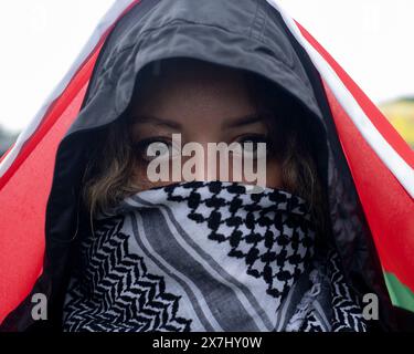 Eine Frau mit palästinensischem Keffiyeh hält eine palästinensische Flagge über dem Kopf, während sie am 18. Mai 2024 an einer pro-palästinensischen Demonstration in Washington DC teilnahm. Pro-palästinensische Demonstranten versammeln sich in der Washington National Mall, um dann den Nakba-Jahrestag in Washington DC zu feiern. Palästinenser und ihre Anhänger auf der ganzen Welt bezeichneten den 76. Jahrestag der "Nakba", als rund 760.000 Palästinenser während der Gründung Israels 1948 aus ihren Häusern flohen oder vertrieben wurden. (Foto: Probal Rashid/SIPA USA) (Foto: Probal Rashid/SIPA USA) Stockfoto