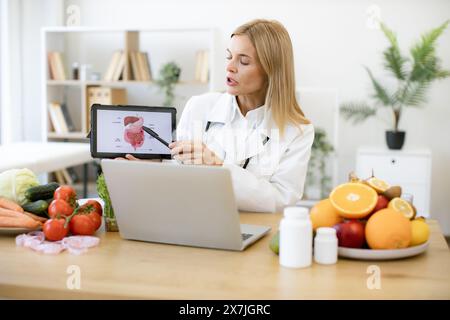 Der kaukasische Arzt in weißem Fell berät ihn aus der Ferne. Stockfoto