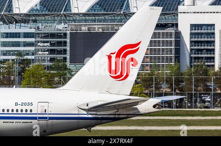 München, 6. April 2024: Heckflosse einer Boeing 777-39L(er) mit Air China Logo, die vom Flughafen München startet. Registrierung B-2035. (Ph Stockfoto