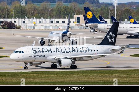 München, 6. April 2024: Ein Lufthansa Airbus A320-214 fährt mit dem Taxi zur Start- und Landebahn am Flughafen München. Das Flugzeug hat eine Star Alliance-Lackierung. (Foto von und Stockfoto