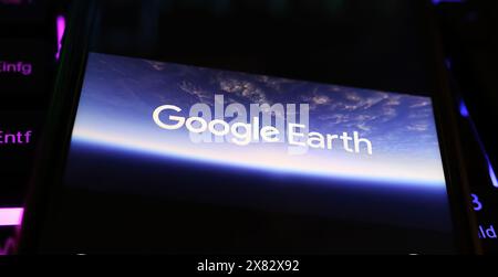 Viersen, Deutschland - 9. Mai. 2024: Nahaufnahme des Smartphones mit Logo-Schriftzug des Google Earth-Programms auf der Computertastatur Stockfoto