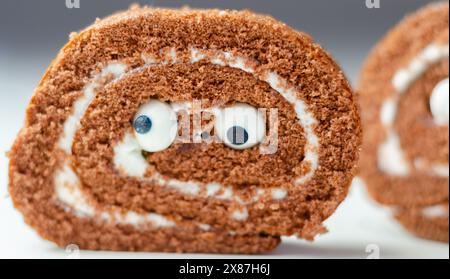 Schokoladenschwammrolle mit Vanillegeschmack, Füllung mit süßen Augen, Schokoladenbrötchen Stockfoto